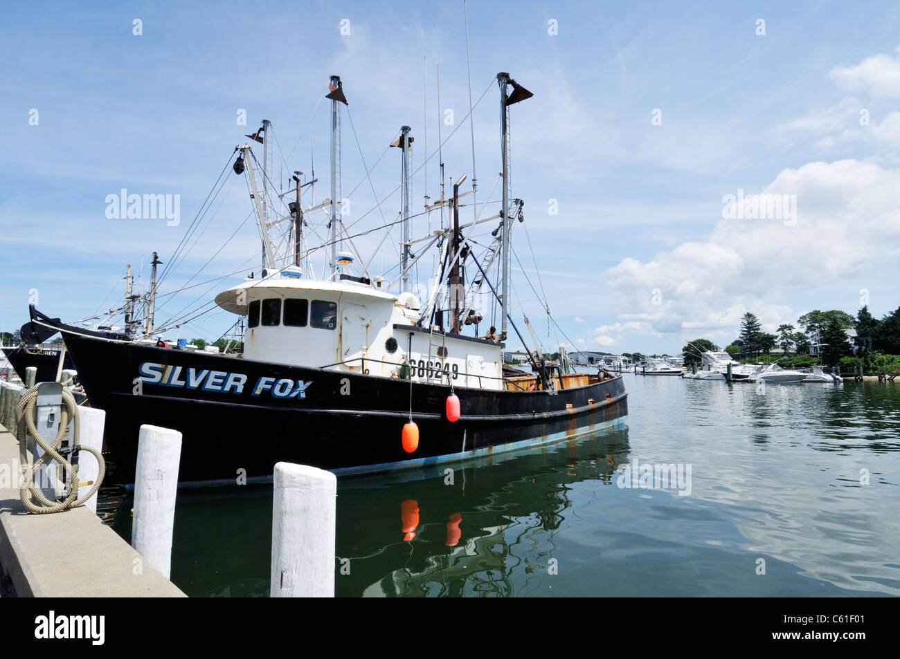 Fishing boat Silver Fox docked in Hyannis Harbor, Cape Cod, USA on a clear blue sky summer day. Stock Photo