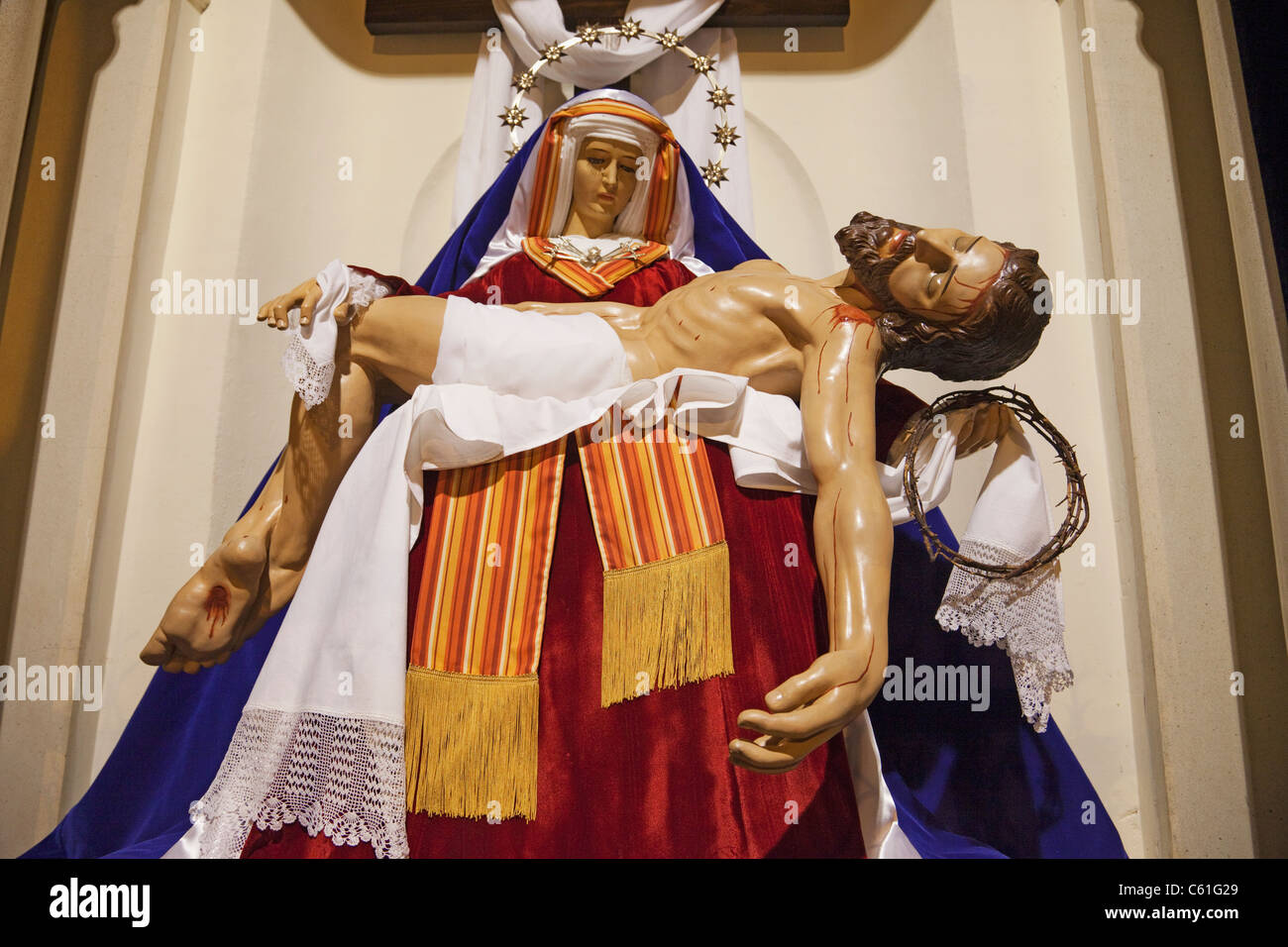 Statue of our lady of sorrows holding jesus christ hires stock