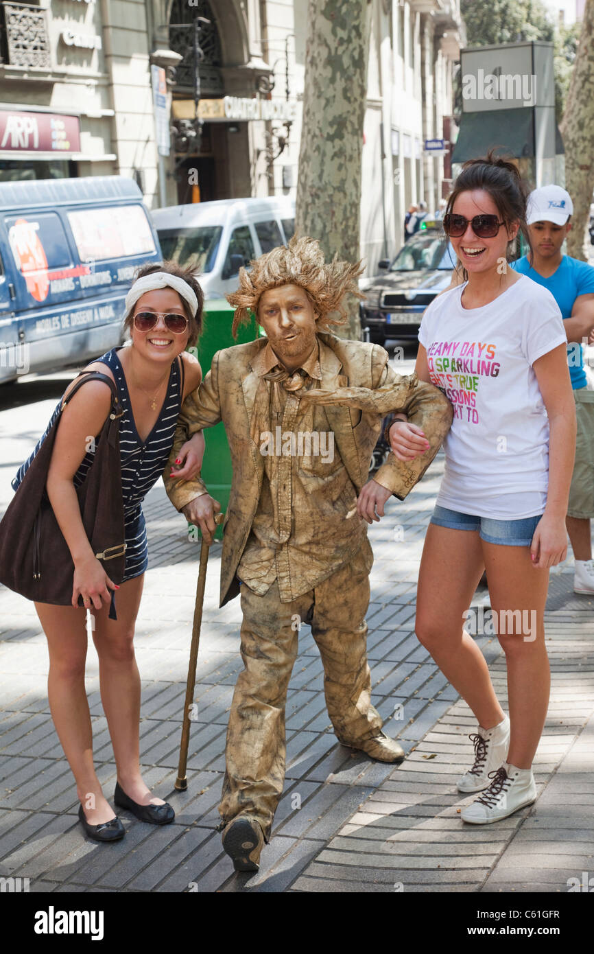 Spain, Barcelona, Las Ramblas, Female Tourists with Human Statue Stock Photo