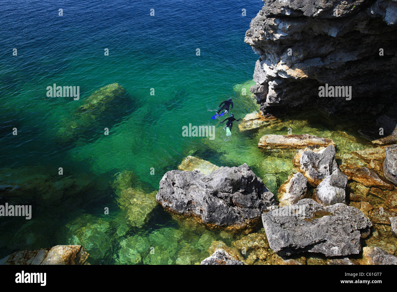 Snorkelers diving near shore in Tobermory, bay, Ontario