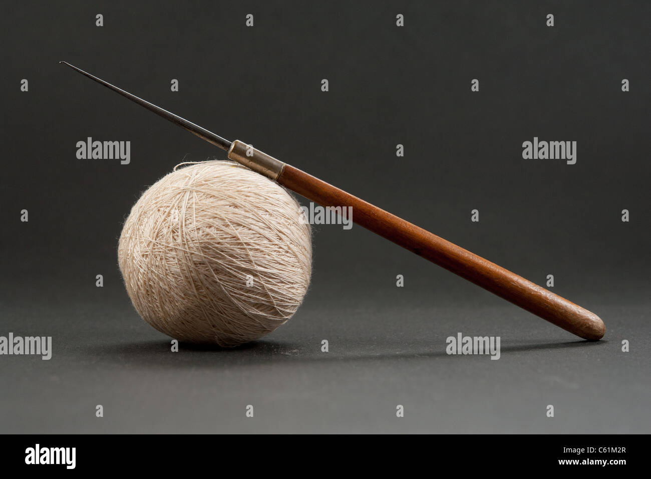 https://c8.alamy.com/comp/C61M2R/vintage-crochet-set-ultra-thin-floss-and-hook-with-wooden-handle-C61M2R.jpg
