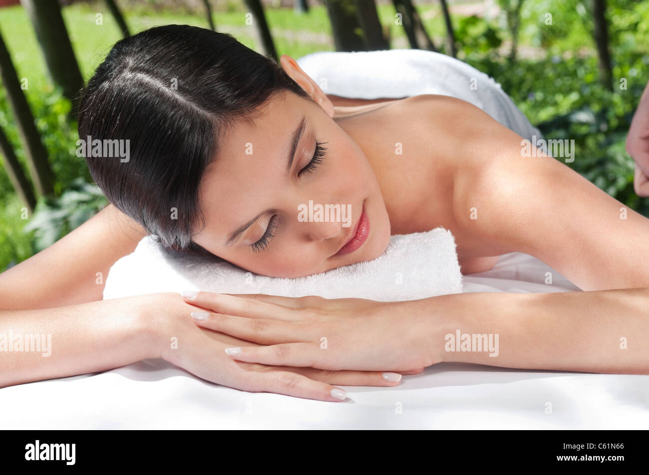 Beautiful young woman relaxing at spa in a natural setting Stock Photo ...