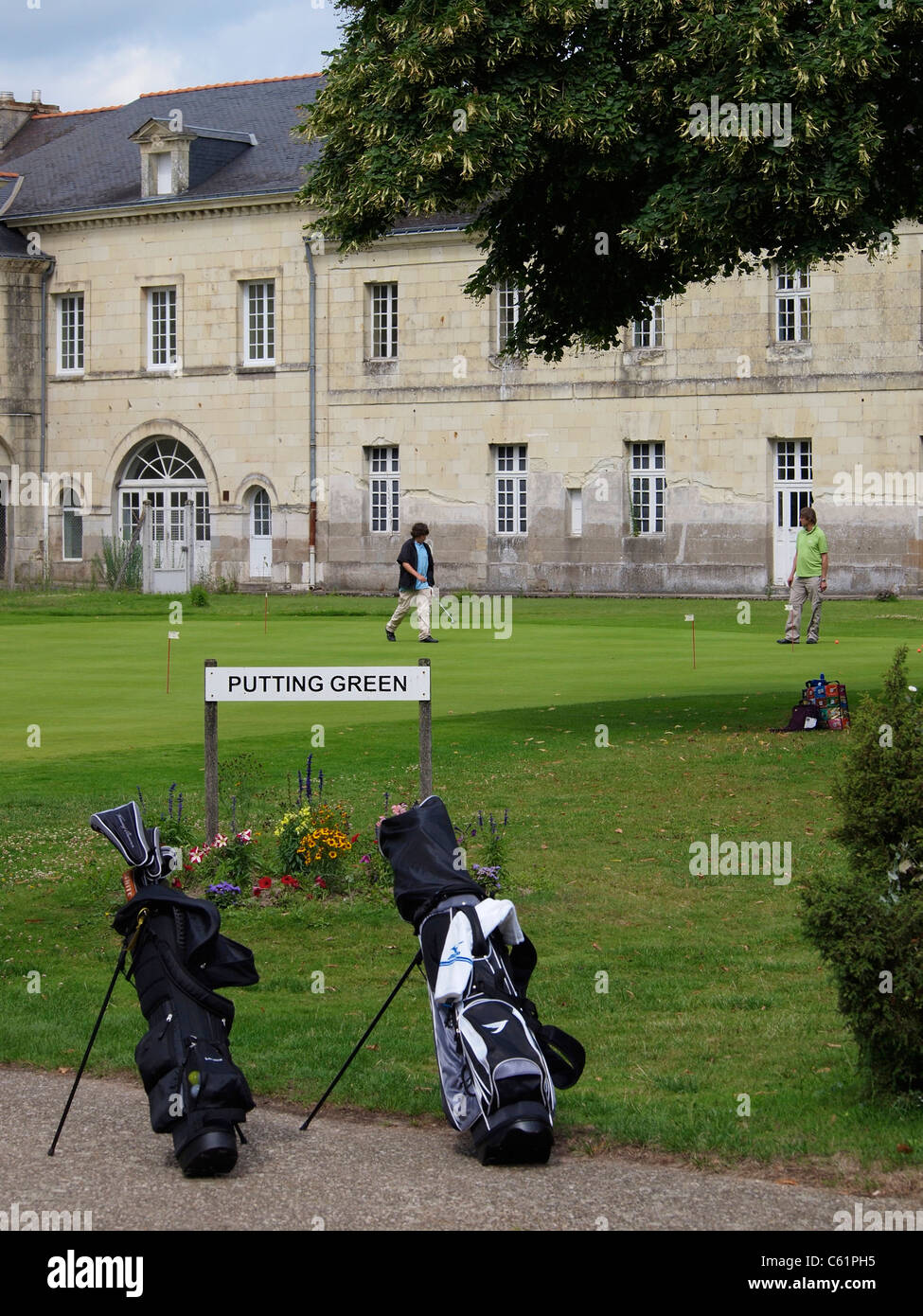 People practicing their golf puts at the putting green of Domaine saint Hilaire resort Stock Photo