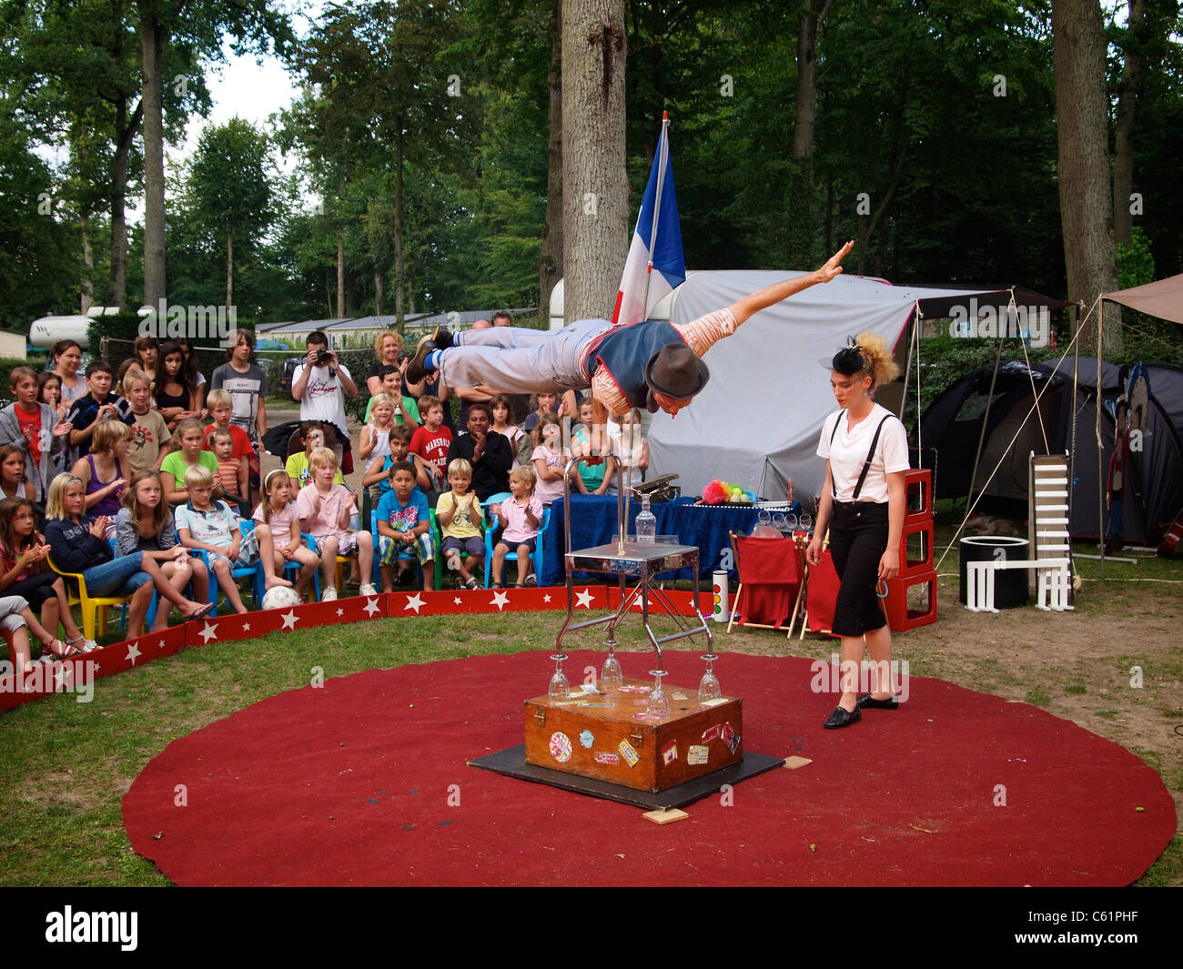 Acrobat in a very small travelling circus performing his act on a camping site near Mer, Loire valley, France Stock Photo