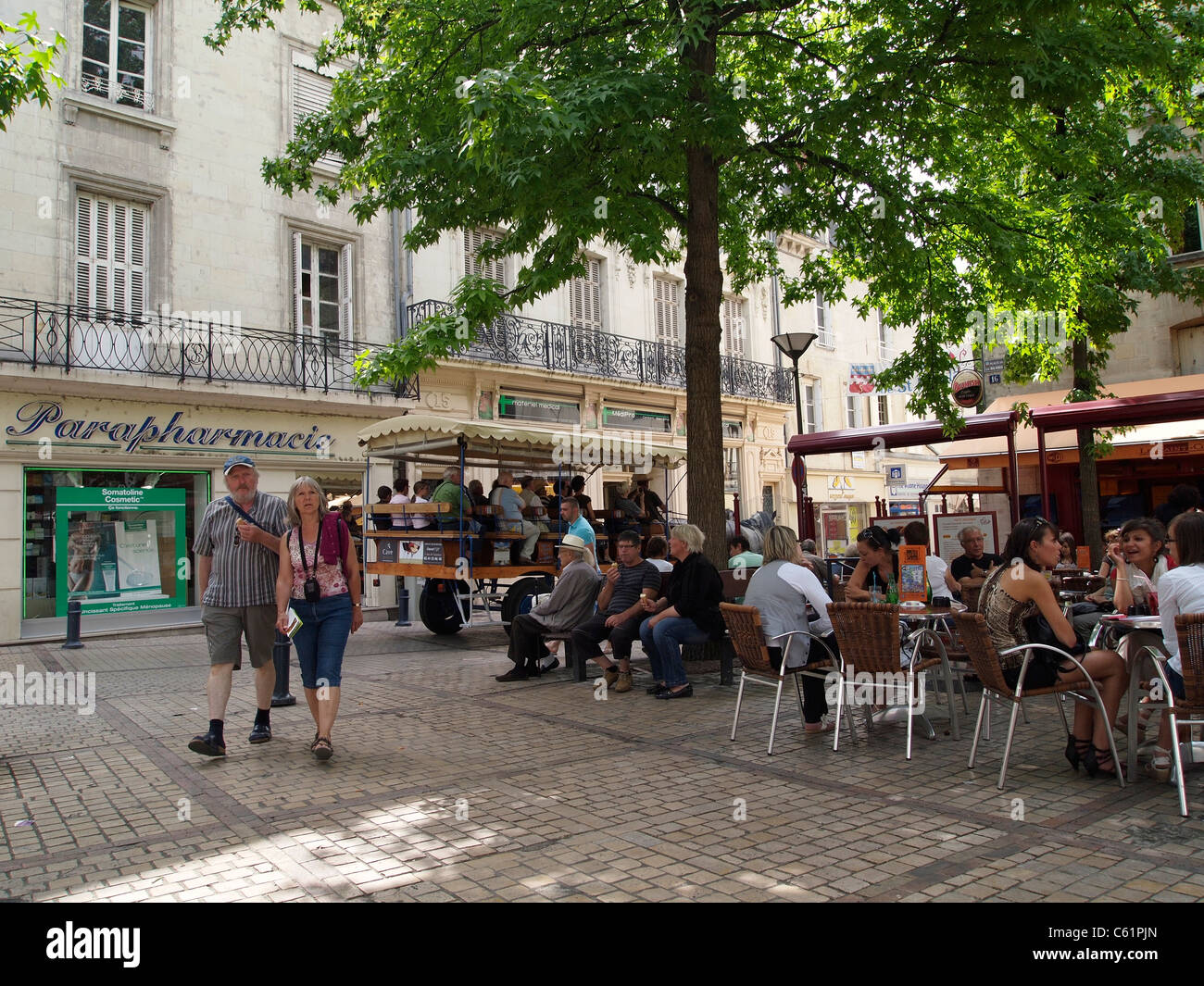 Tourists sitting in the shade on a square in Saumur, Loire valley, France Stock Photo