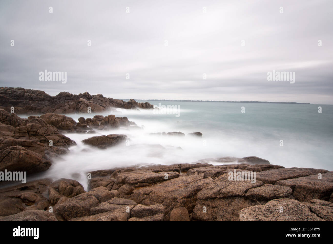 Long exposure photograph of waves covering the rocks in Brittany ...