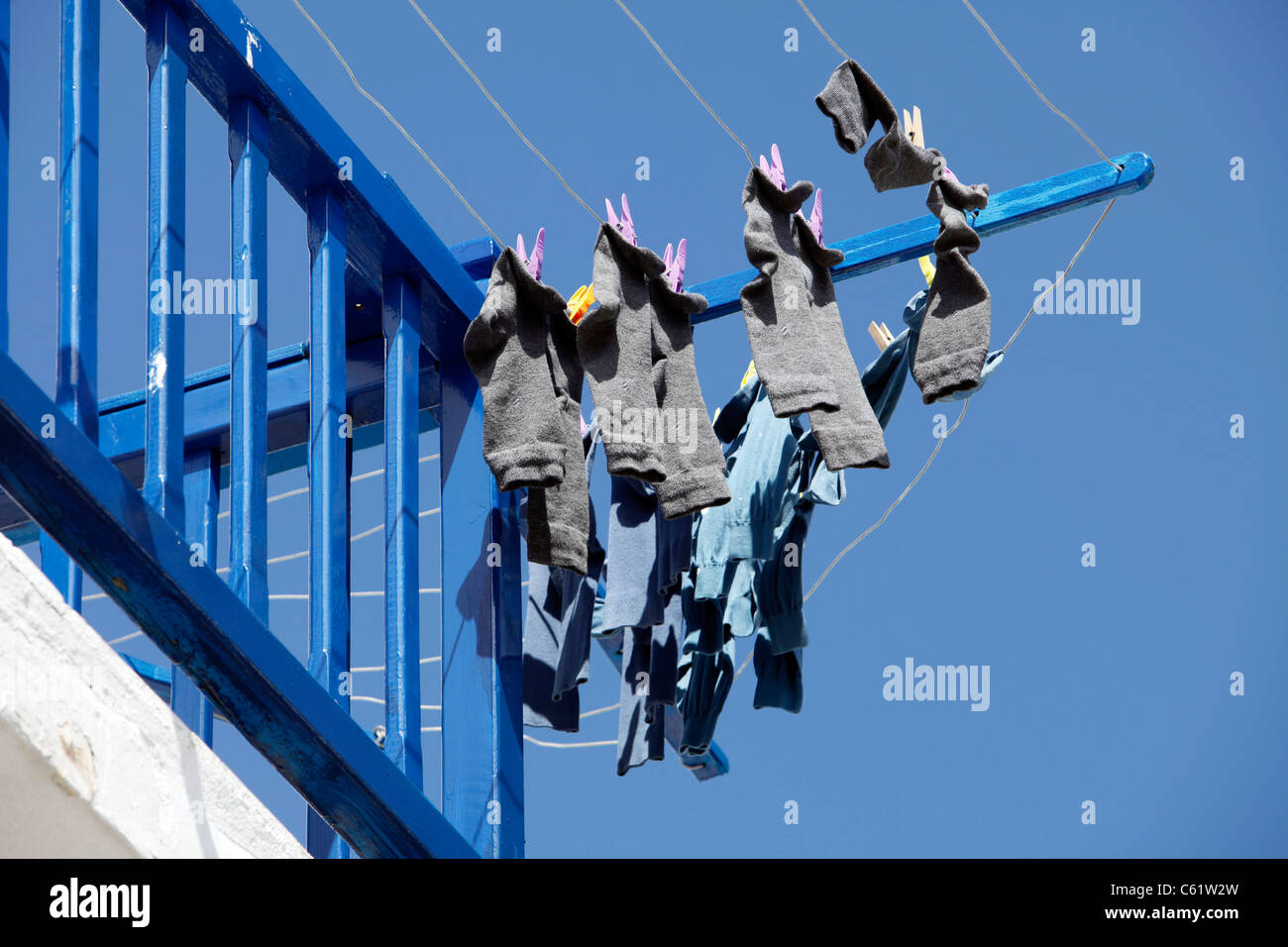 Socks hanging out for drying, laundry, old town of Mykonos, Greece, Europe. Stock Photo