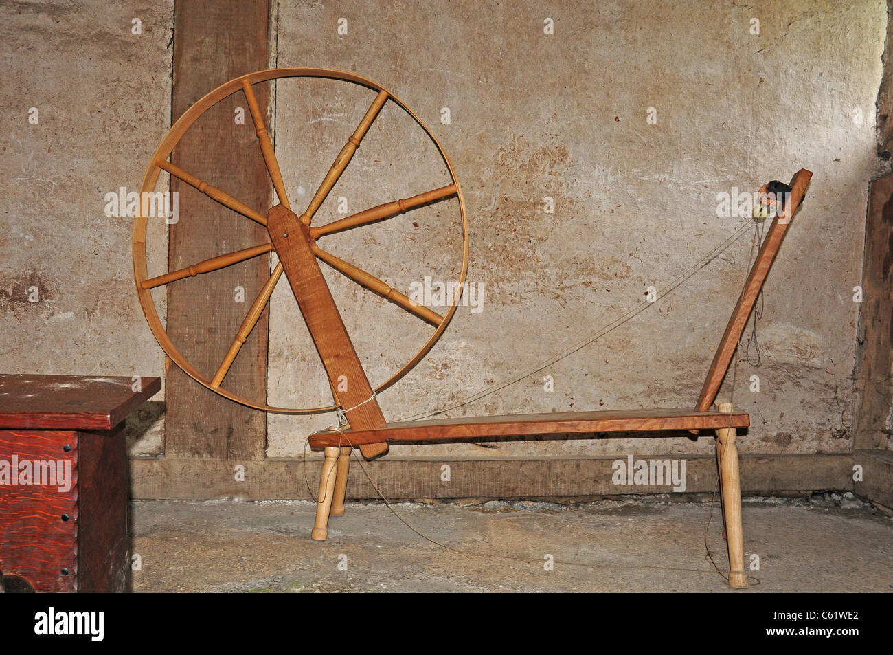 Spinning wheel exhibited in Bayleaf Farmhouse, Weald and Downland Open Air Museum. Stock Photo