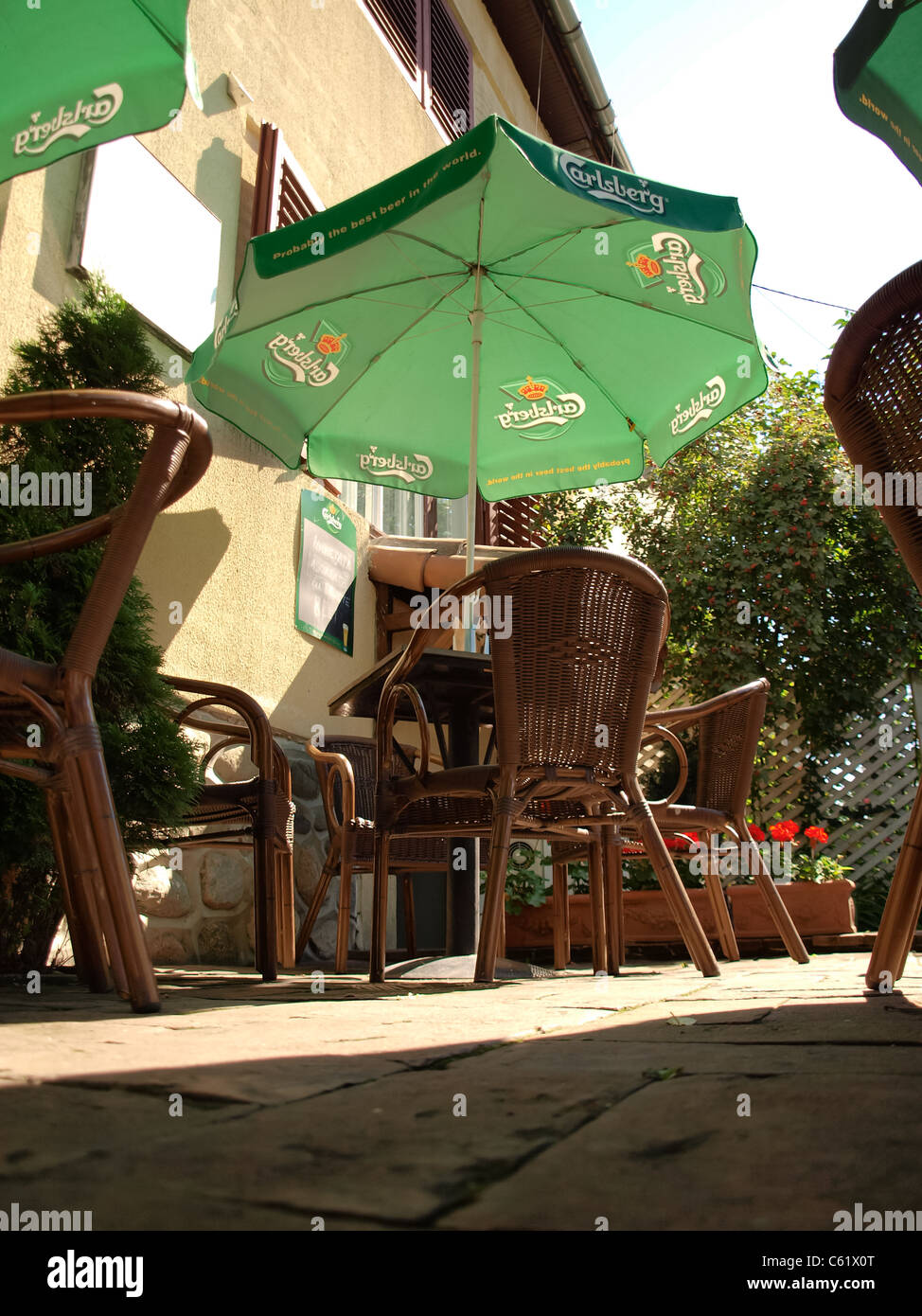 carlsberg patio umbrella Carlsberg umbrella in an open bar Stock Photo