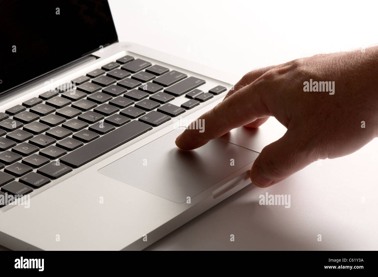 Finger touching mouse pad on laptop Stock Photo Alamy