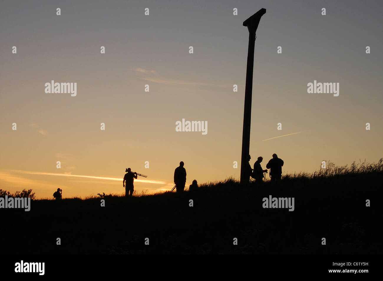 Combe Gibbet silhouetted against sunset Stock Photo