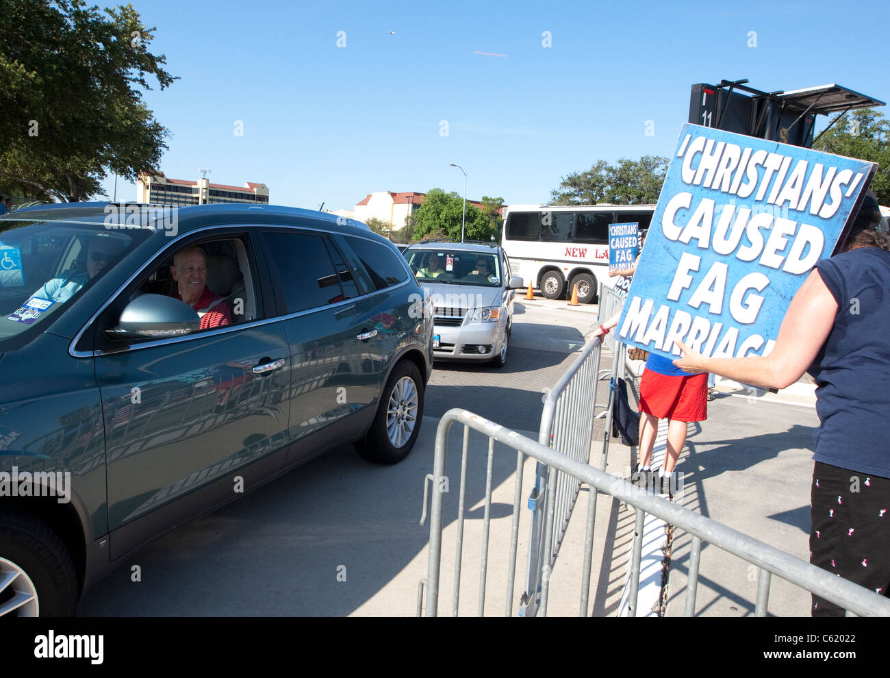 Onlookers in car look at protesters from the Westboro Baptist church known for its position against homosexuality Stock Photo