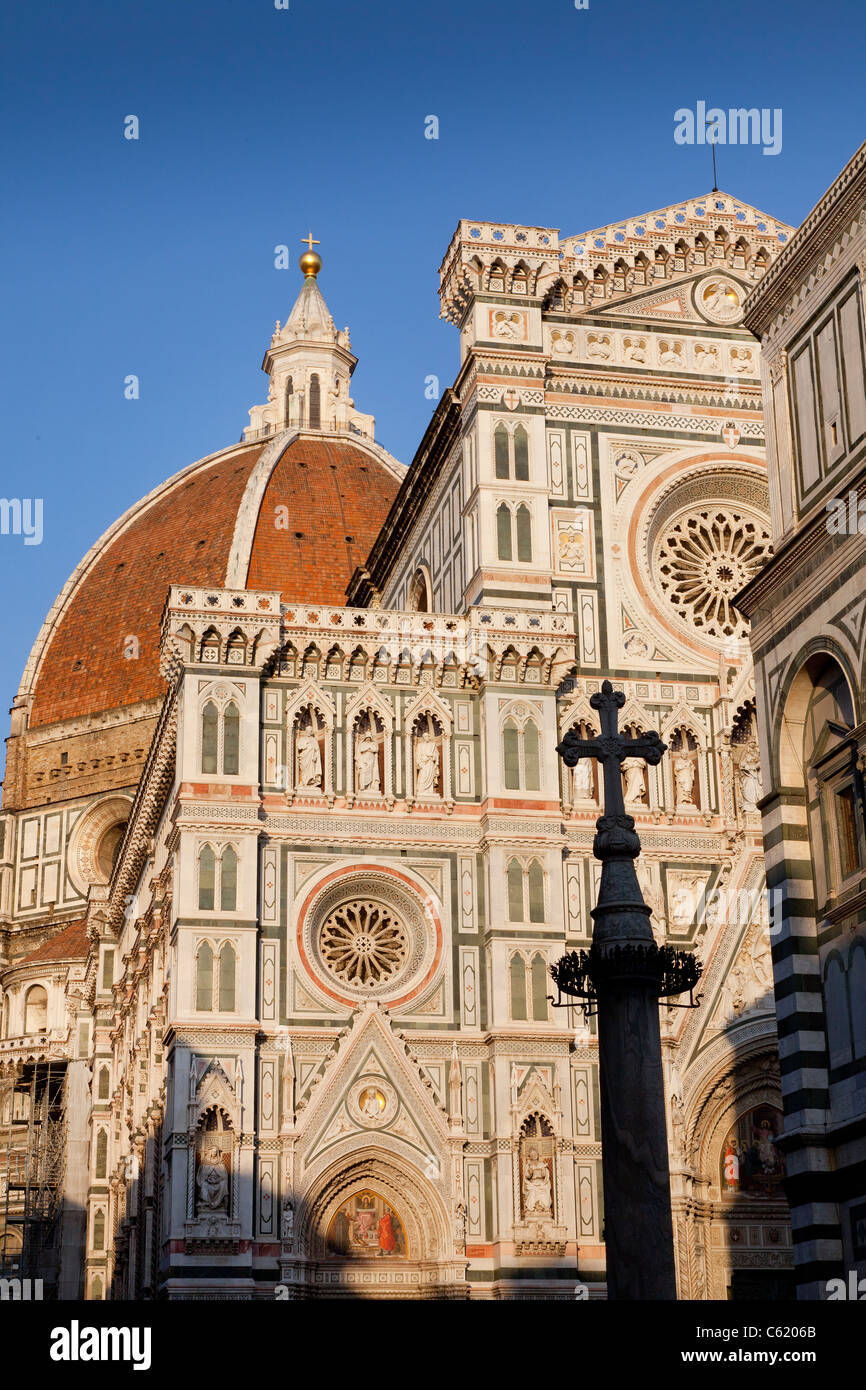 The Basilica di Santa Maria del Fiore, Duomo, Florence, evening sunlight illuminates the facade. Stock Photo