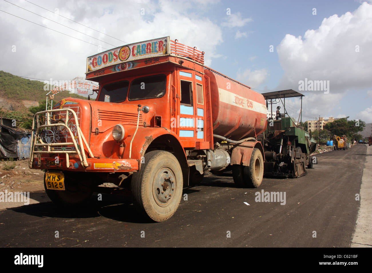 Vintage Tata 1210 SE water bowser supplying water on country road construction near Pune India Stock Photo