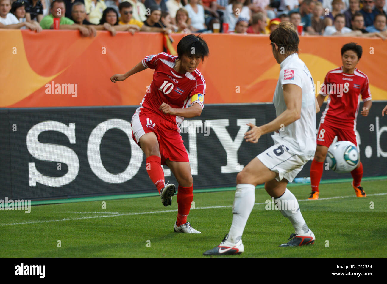 North Korea team captain Yun Mi Jo (10) crosses the ball during a 2011 Women's World Cup match against the United States. Stock Photo