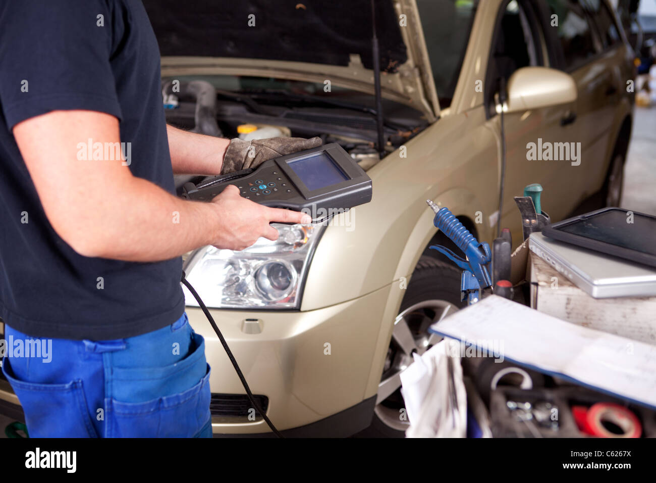 Detail of a mechanic with an electronic engine diagnostics tool Stock Photo Alamy