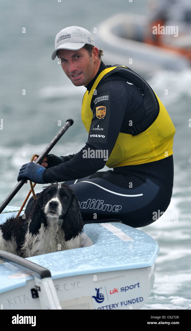 UK, Olympic Test Event, Ben Ainslie with dog friend 'Kim' after he won gold for Great Britain in the Finn Class Stock Photo
