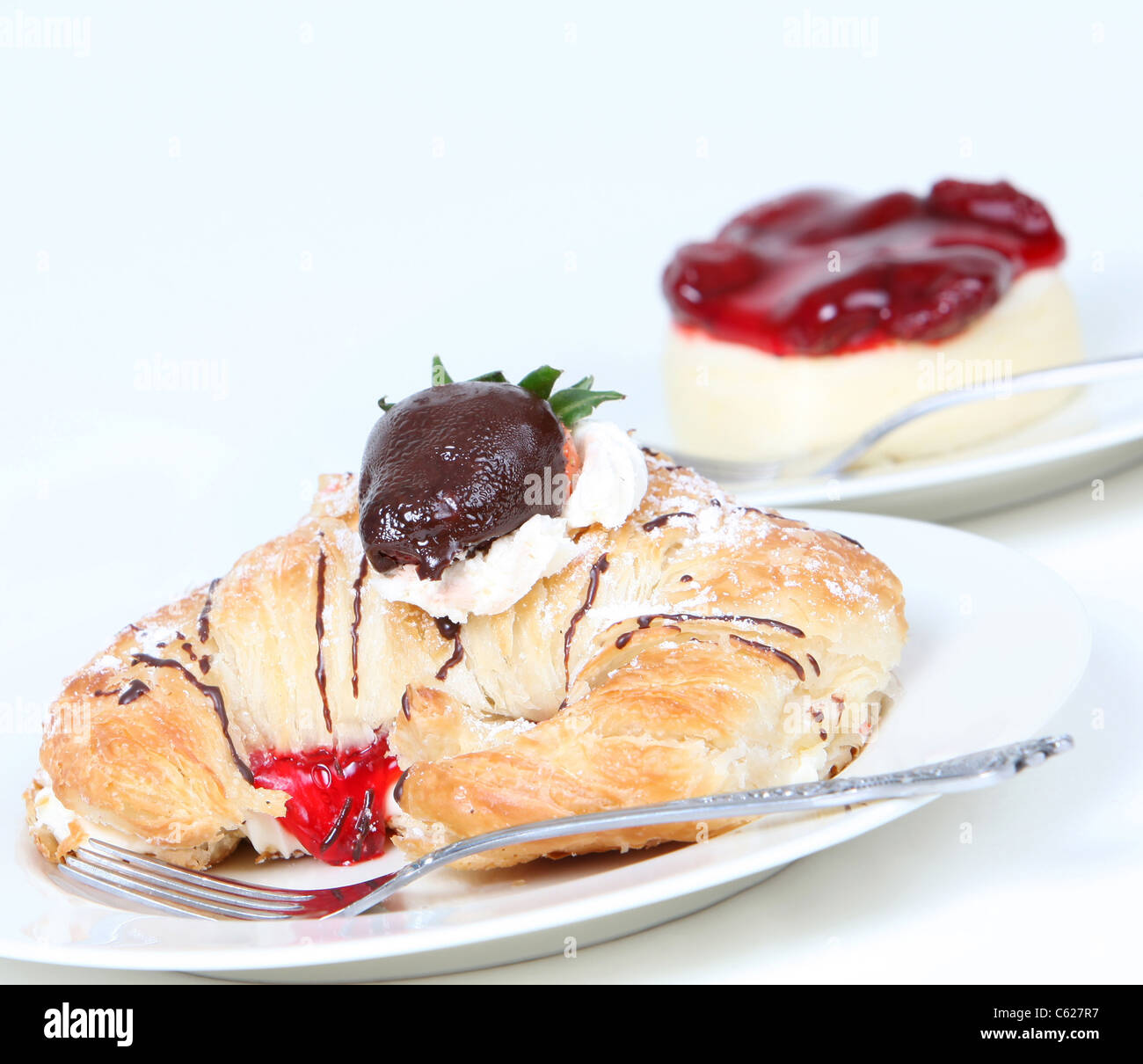 Cream filled croissant with chocolate strawberry and cheesecake Stock Photo