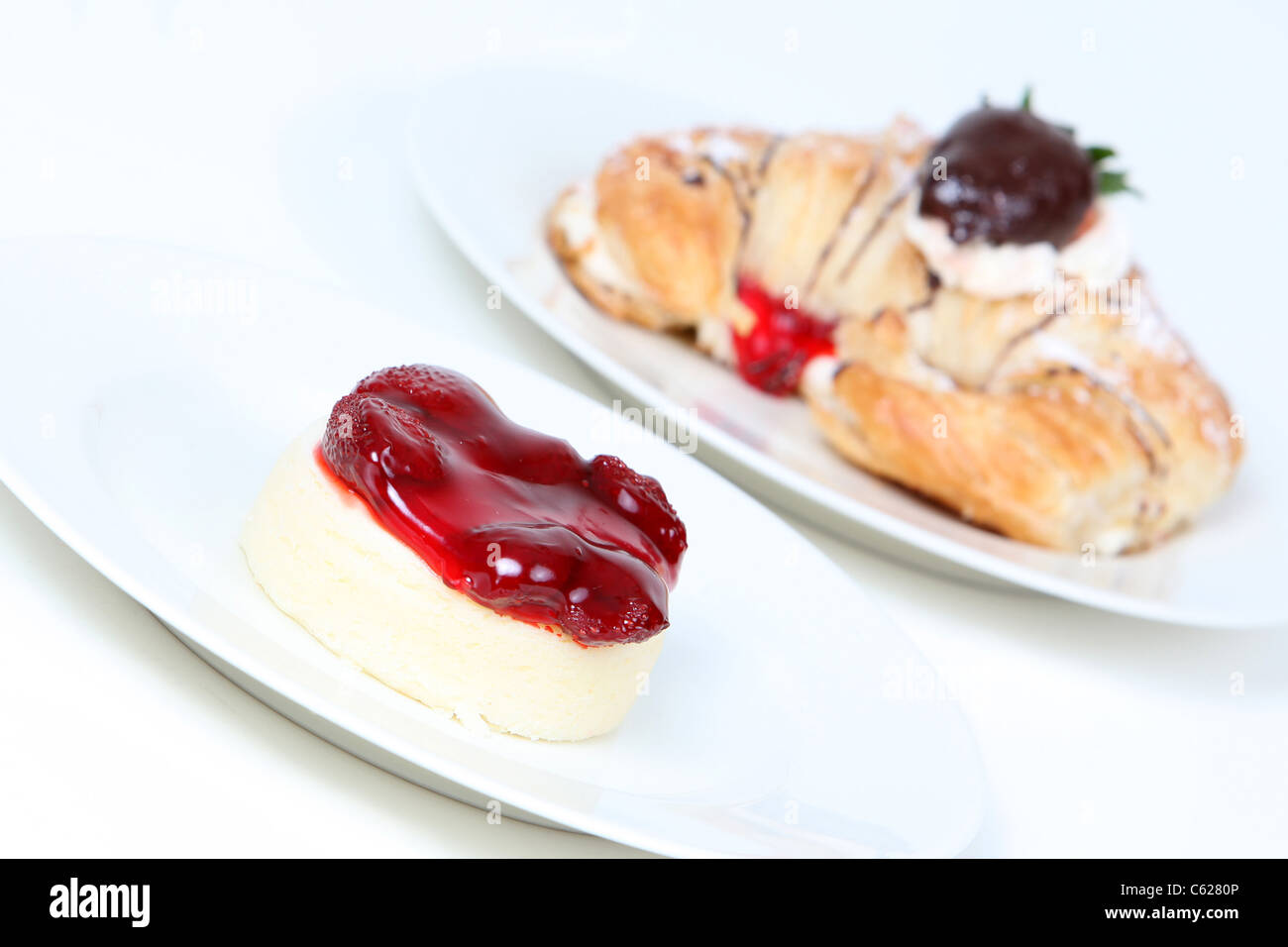 Strawberry cheesecake and creme filled croissant with chocolate strawberry Stock Photo