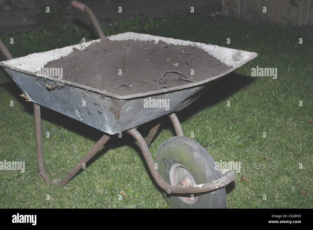 image of old wheelbarrow full of soil Stock Photo - Alamy