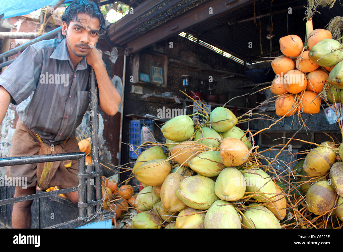 Indian tender coconut vendor at a street shop in India. Location - Trivandrum, Kerala. Stock Photo
