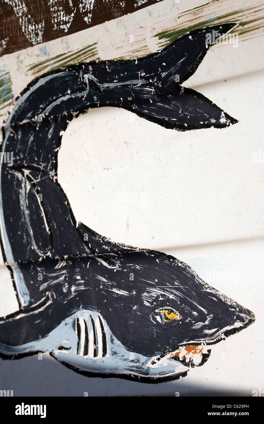 Painting of shark on a fishing boat on the beach Stock Photo