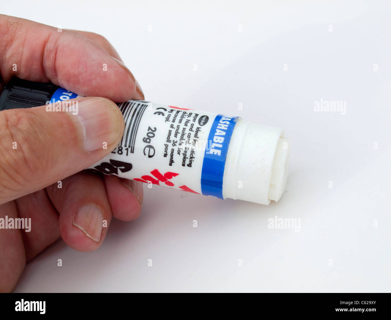 Pritt stick gum glue for paper held in a man's hand Stock Photo - Alamy