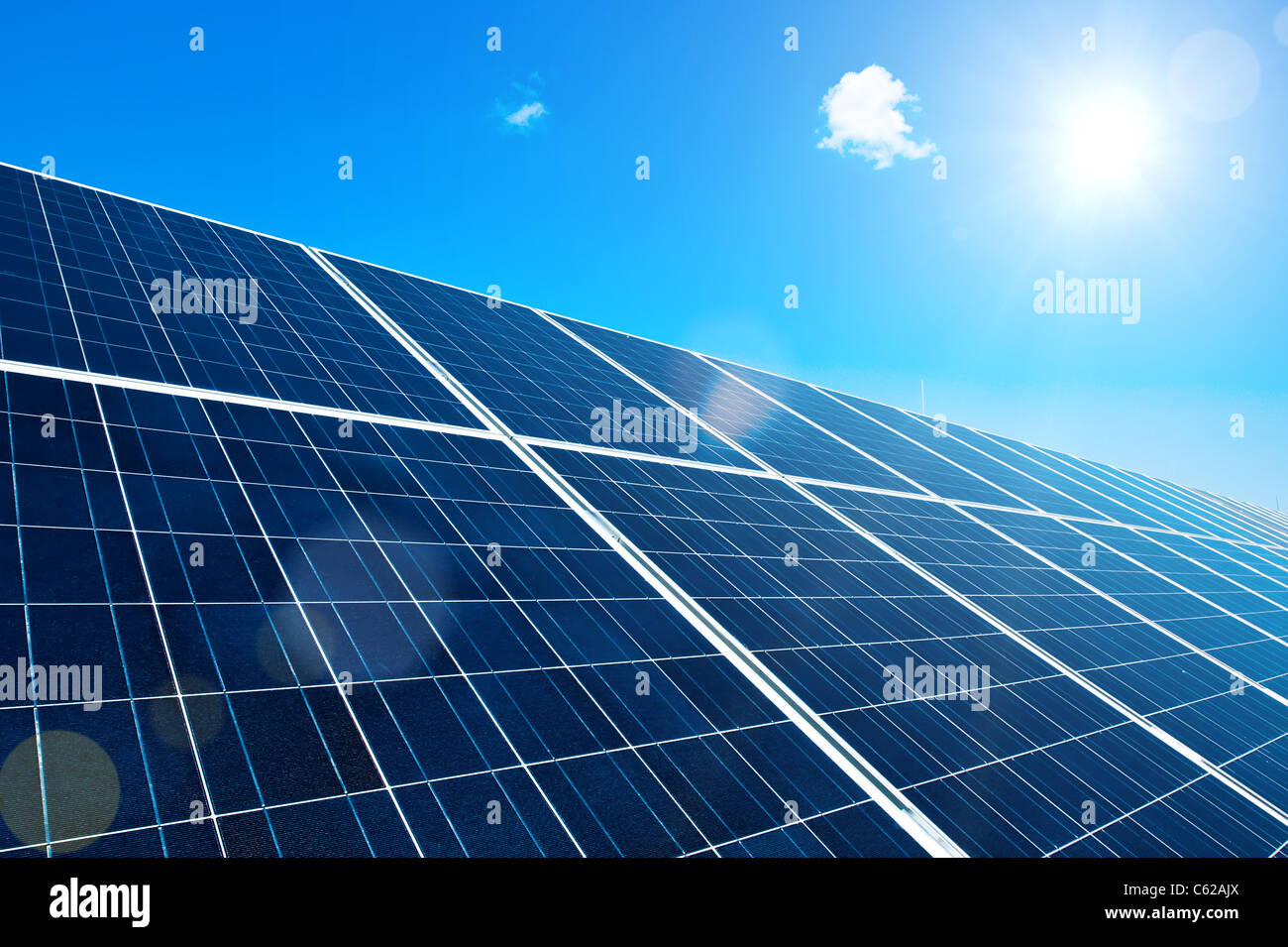 Solar Panel with Sun and Lens Flares and blue Sky Stock Photo