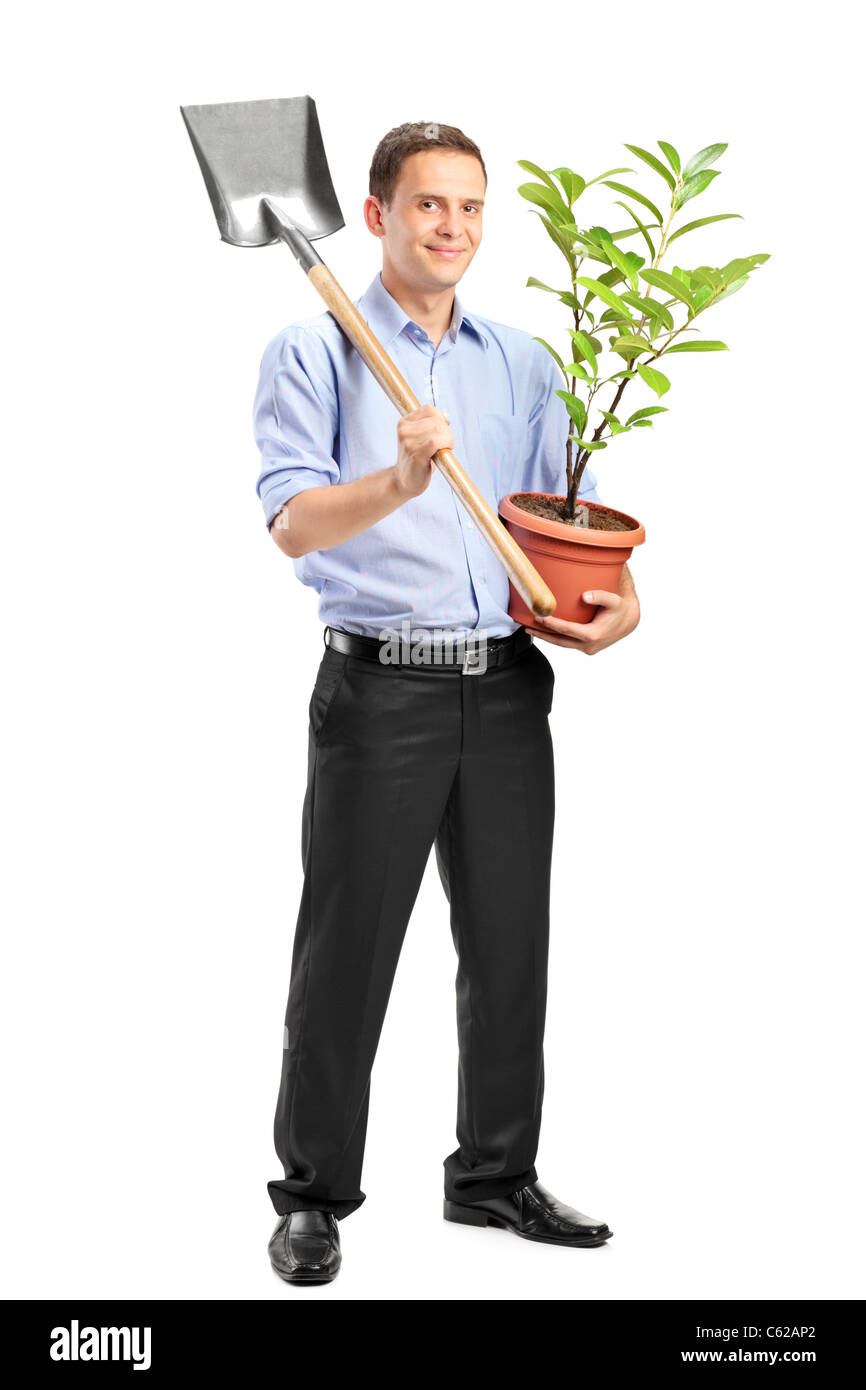 Full length portrait of a smiling man holding a potted plant and a ...