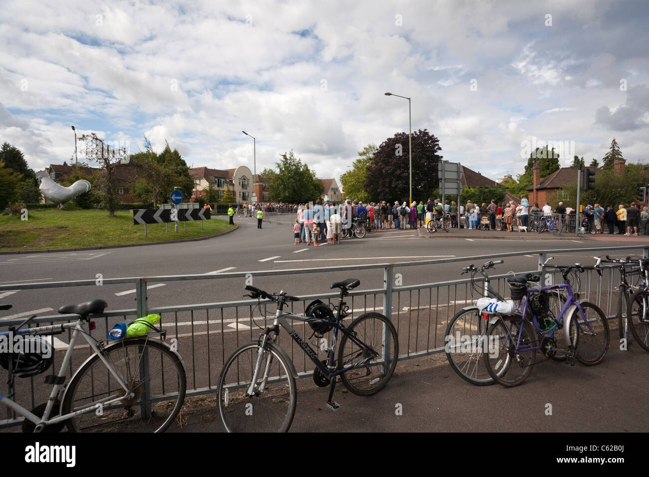 Crowds gather at the roadside to watch participants of the London Surrey Classic cycle event at the junction of the A24 and A25 Stock Photo