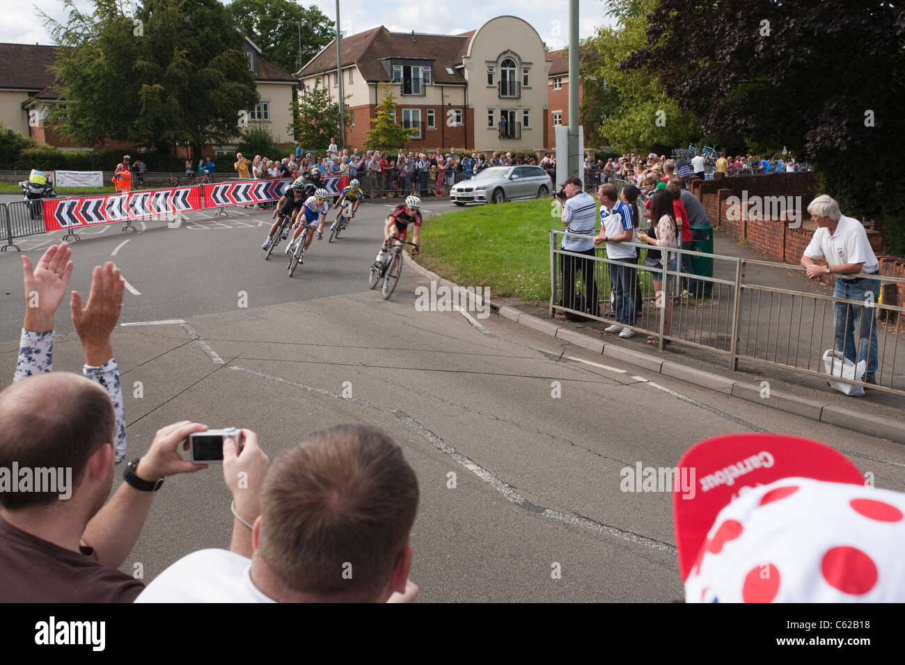 The leading group in the London Surrey Classic turns sharply left out of Dorking and heads down the A24 towards Box Hill Stock Photo