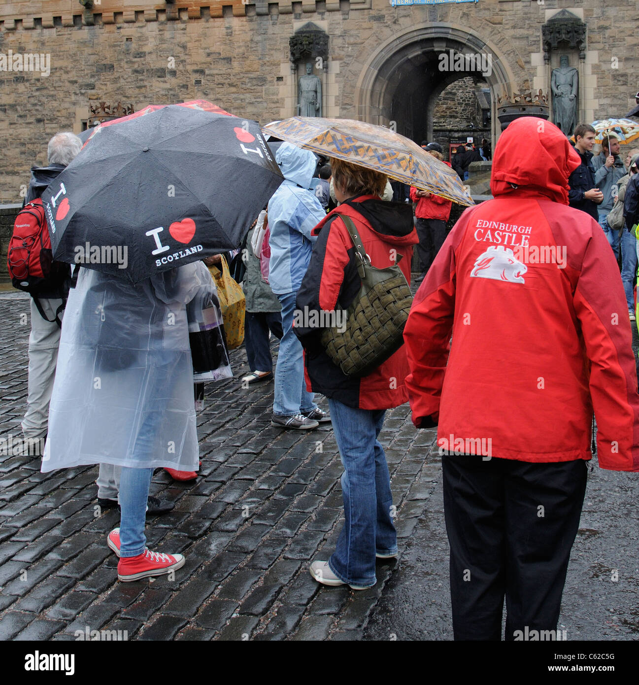 Tourists and umbrellas on a wet day for visitors to Edinburgh Castle