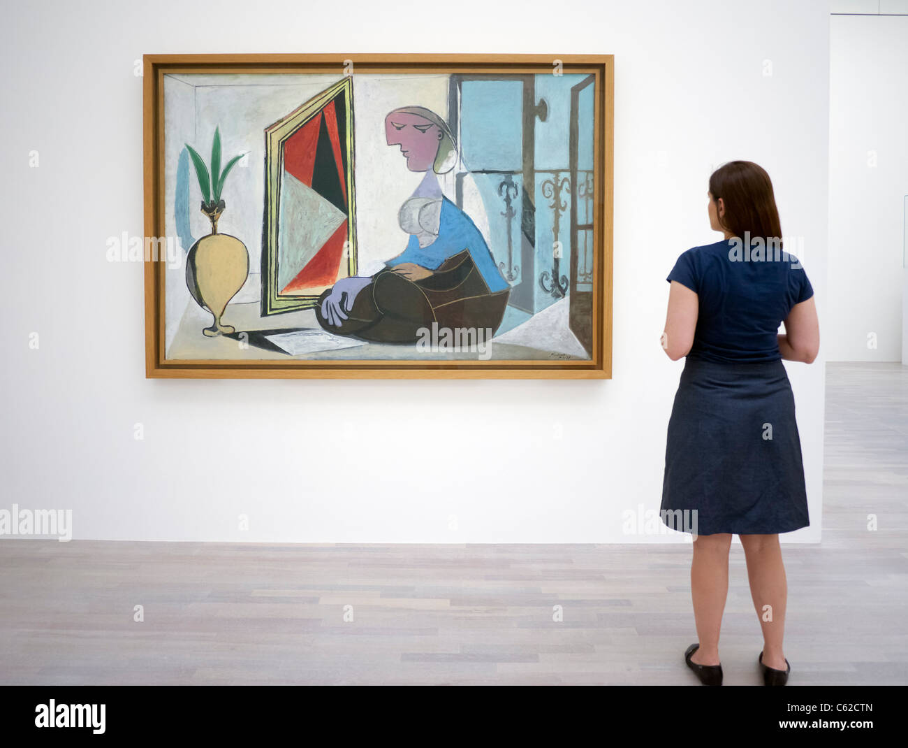 Woman looking at painting Femme au Miroir ( Femme accroupie) by Pablo  Picasso at art museum K20 or Kunstsammlung at Grabbeplatz Stock Photo -  Alamy