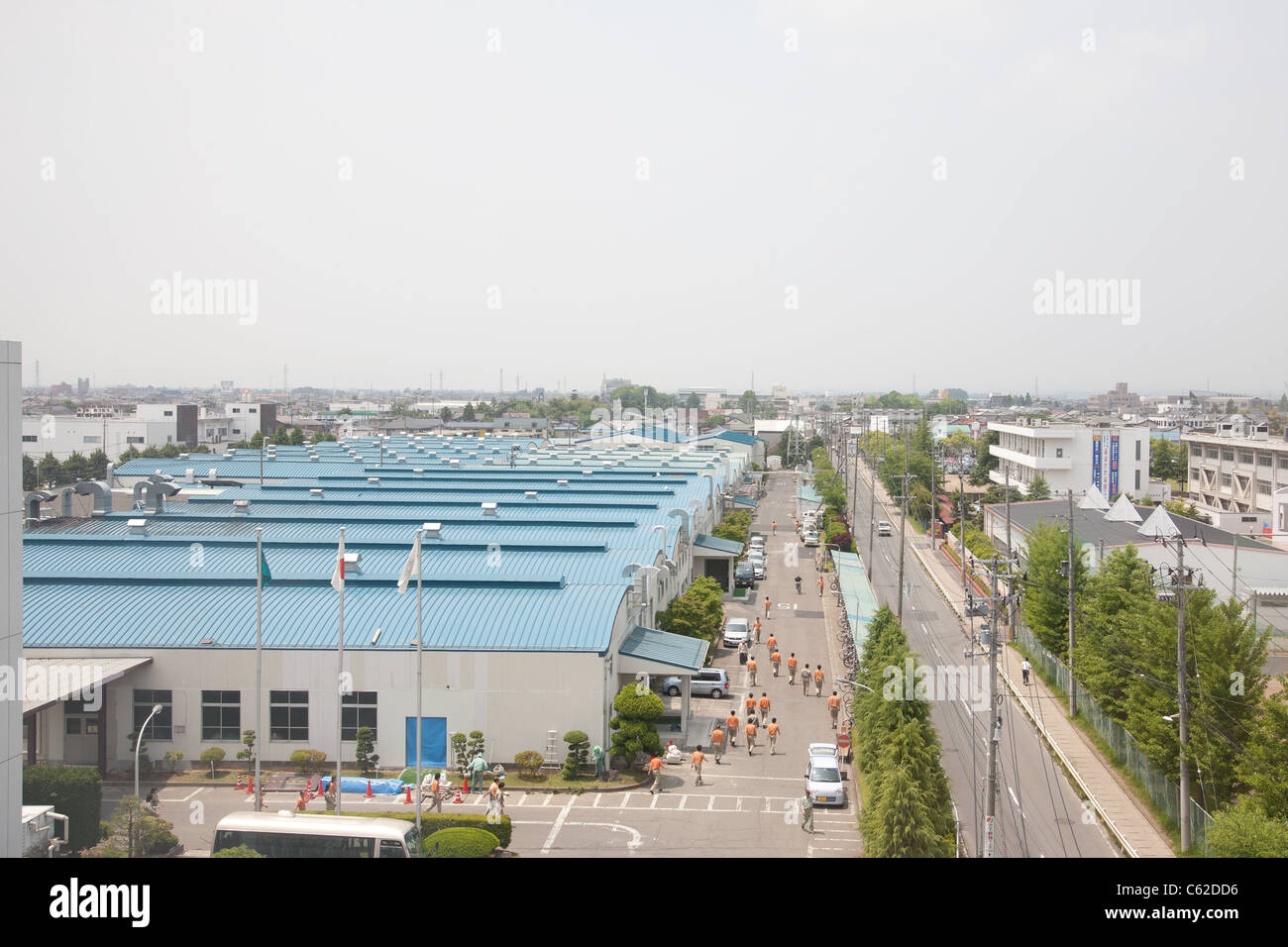 Japanese factory workers at work near Sendai, Japan, June 2011. Stock Photo