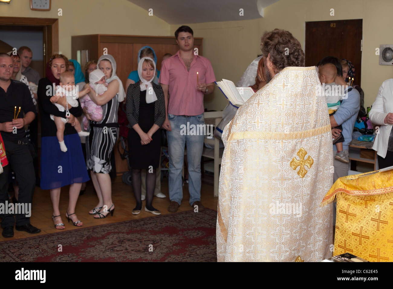 Baptism in Russian orthodox church. Priest christening the all people. Ceremony of christening