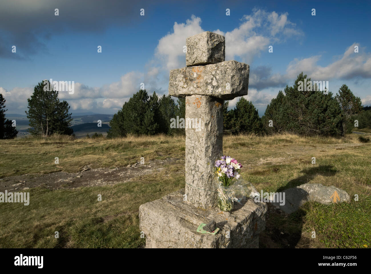 France, Auvergne, Haute Loire departement. Stone cross at the foot of the Mont Mezenc Stock Photo