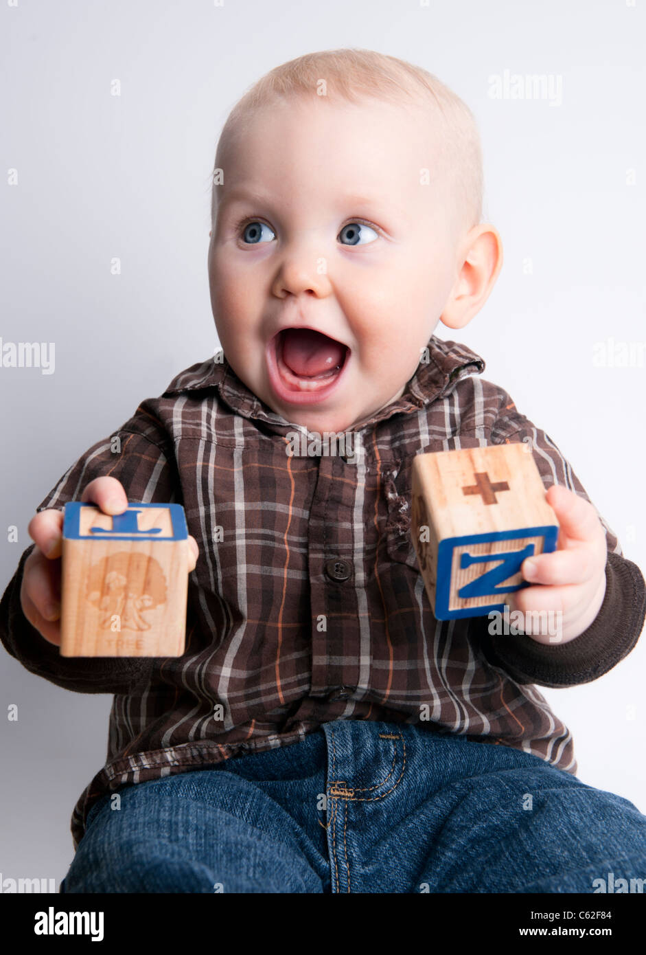 Nine month old baby boy smiling, laughing, playing with learning blocks Stock Photo Alamy