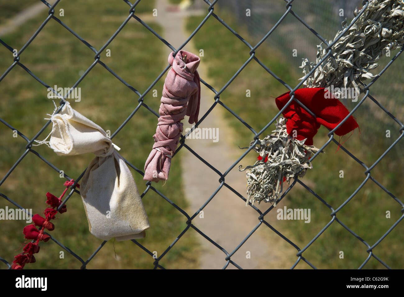 Ceremonial tobacco offerings on Wounded Knee mass grave fence on Oglala