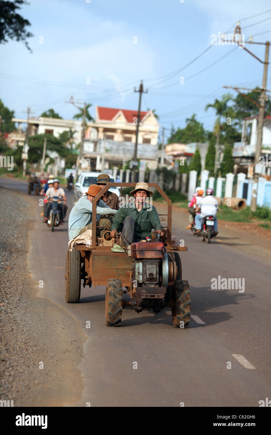 Men on a tractor, the most common work vehicle in the central highlands. Buon Ma Thuot, Dak Lak, Vietnam, South-East Asia, Asia Stock Photo