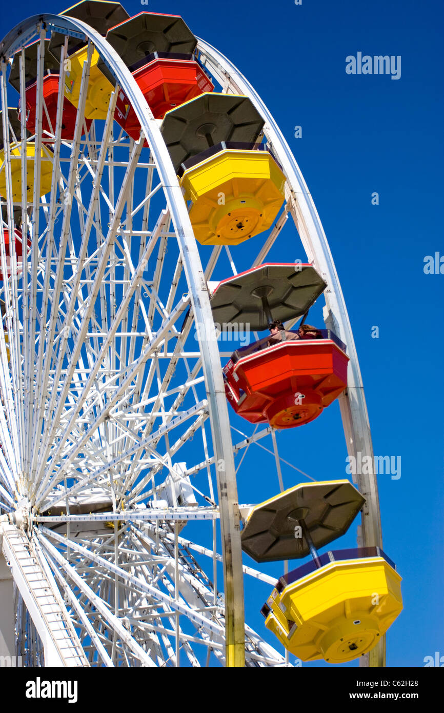A couple riding a ferris wheel on a clear day Stock Photo