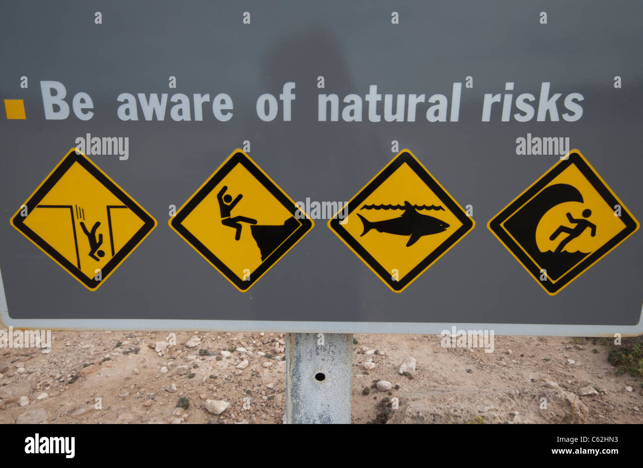 Sign warning of a number of 'natural risks' on the Australian coastline Stock Photo
