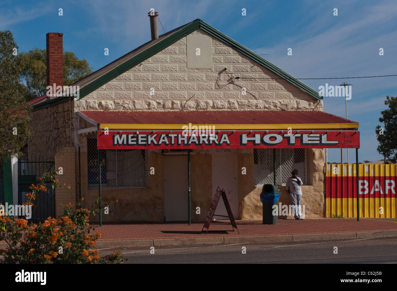 An aboriginal woman stands outside the Meekatharra Hotel in Western Australia Stock Photo