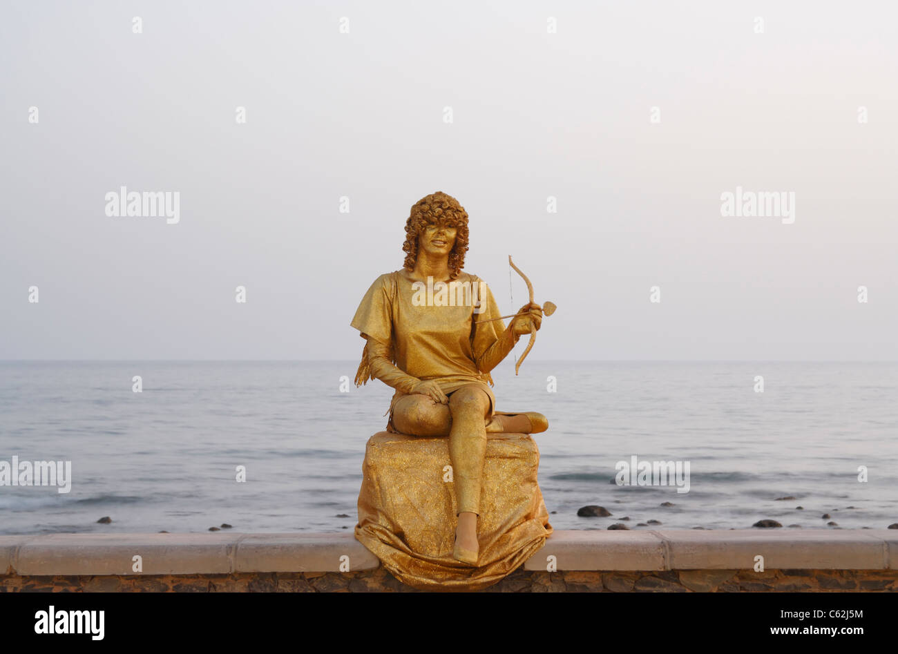 Human statue busker dressed as Cupid in Maspalomas, Gran Canaria Stock Photo