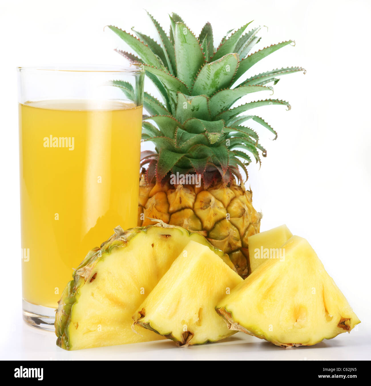 Pineapple juice in a glass of pineapple slices. Image on white