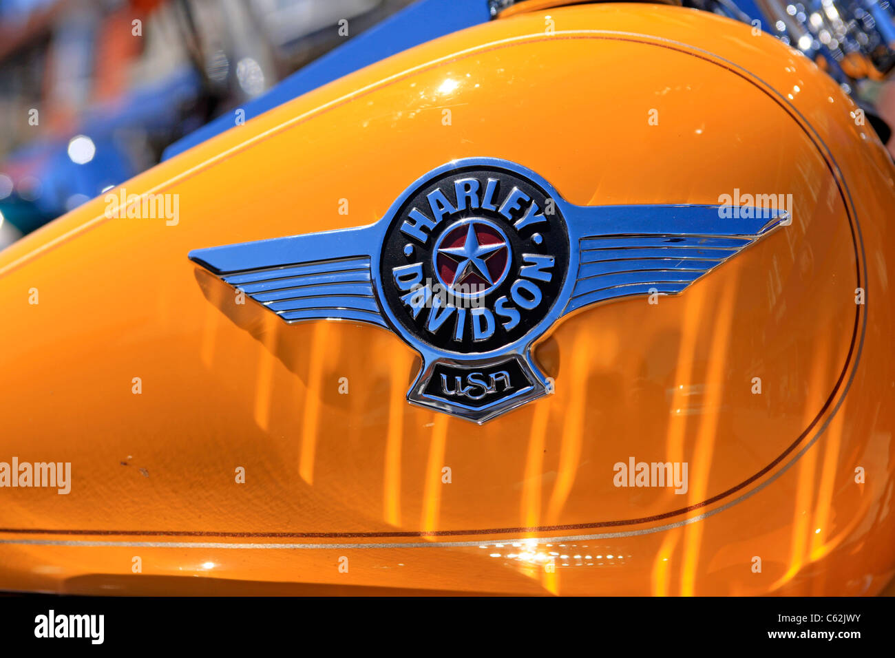 Harley Davidson logo on the yellow petrol tank of a motorcycle Stock Photo