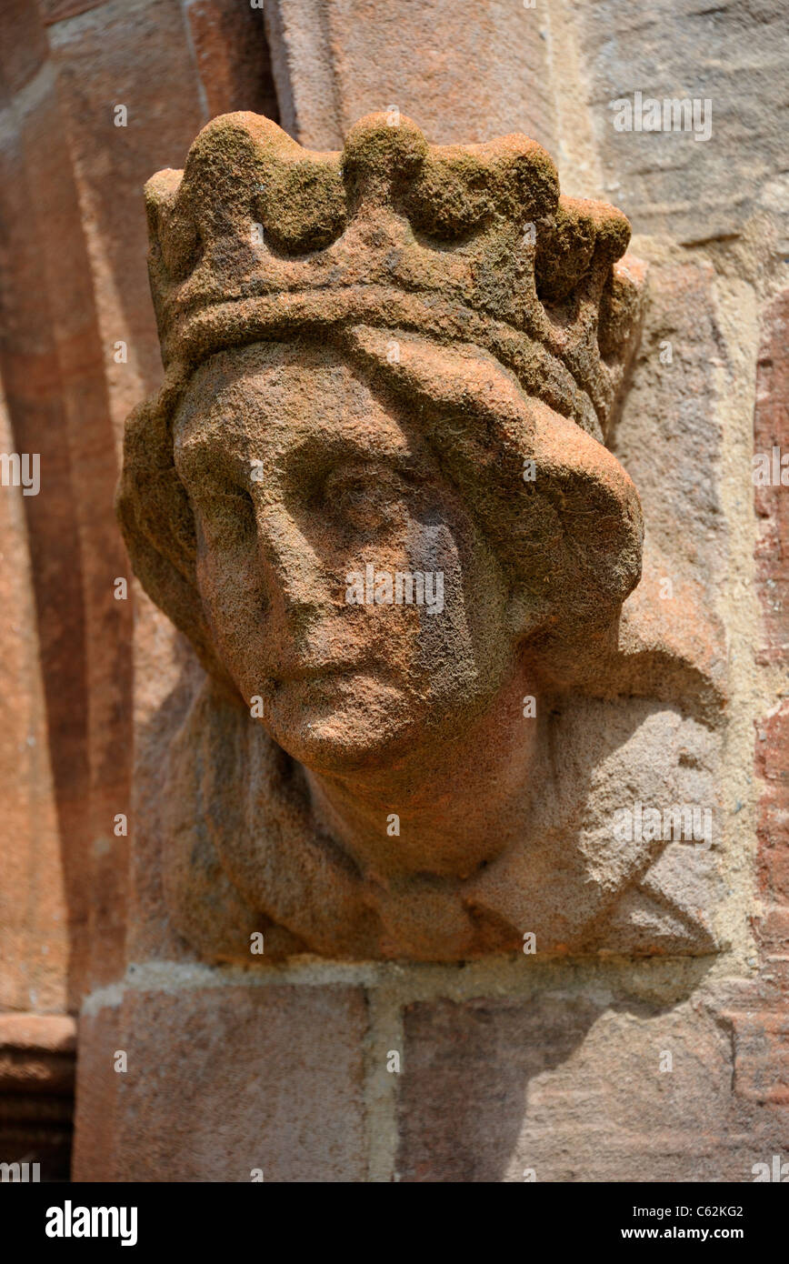Sculpted female head at West doorway, Church of Saint John. Skirwith, Cumbria, England, United Kingdom, Europe. Stock Photo