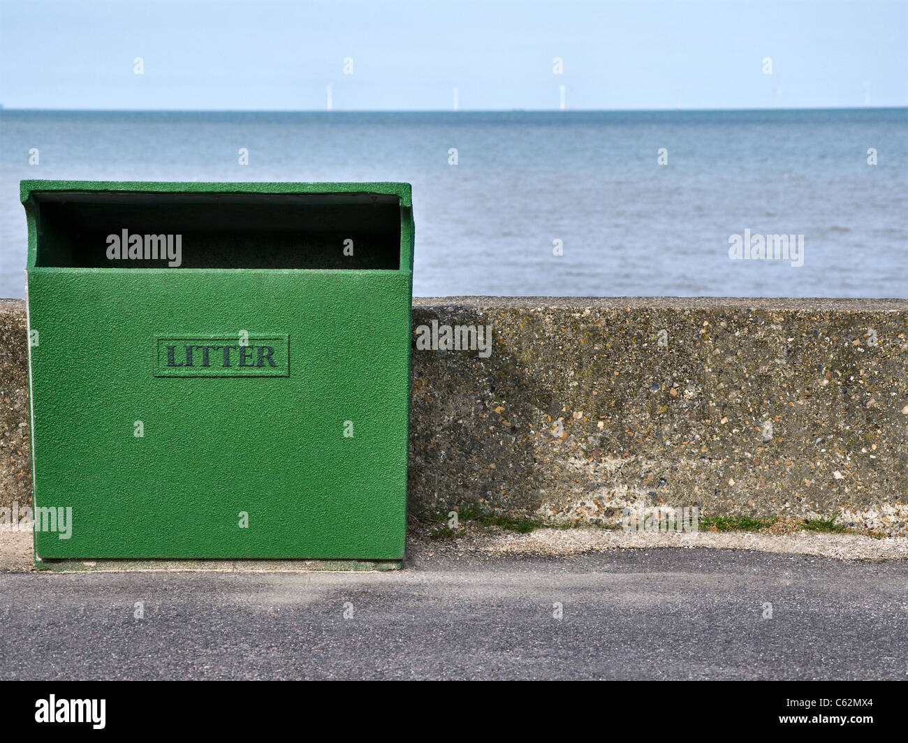 Large green public litter bin on the seafront. keep Britain tidy Stock