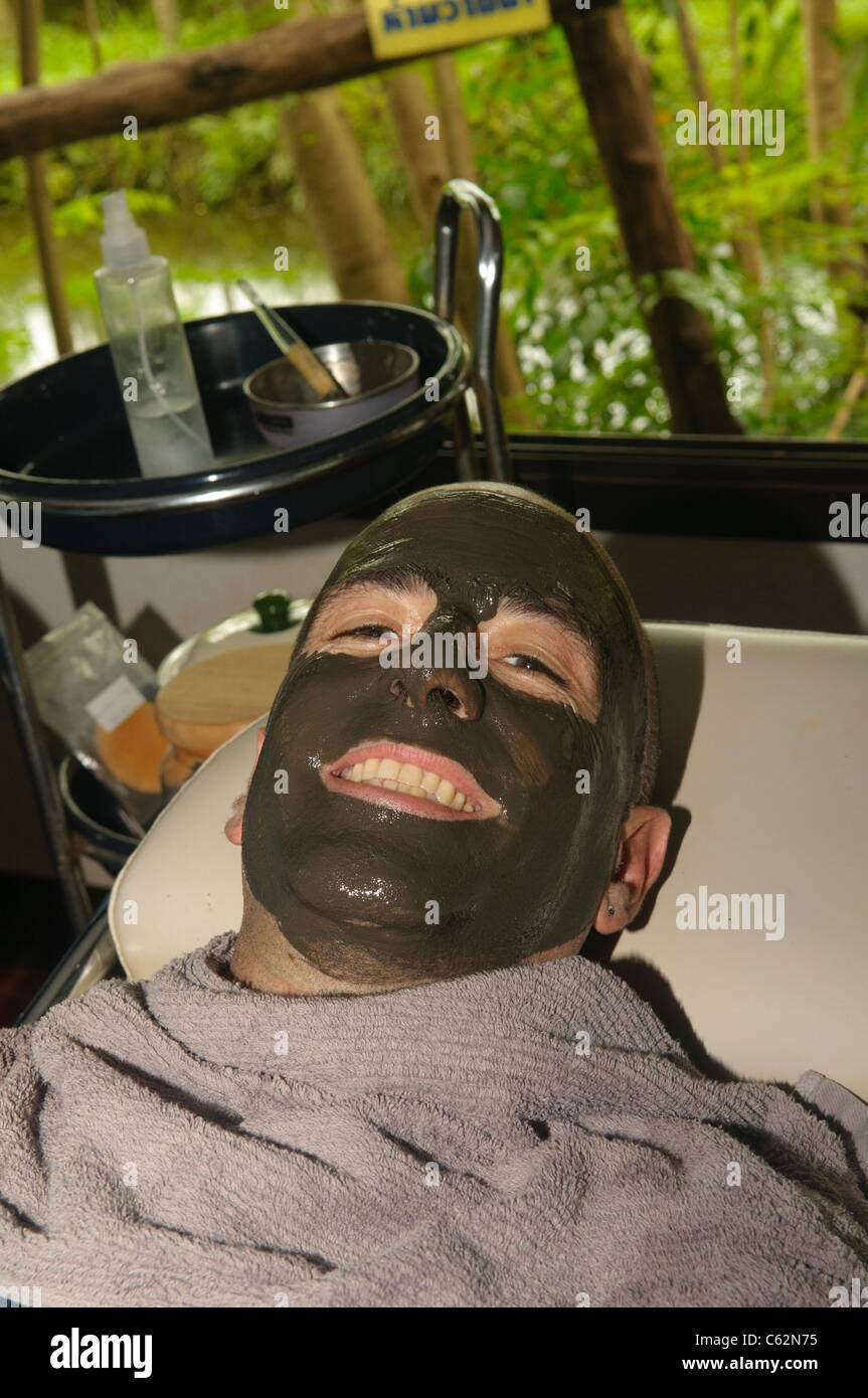 tourist enjoying a therapeutic mud treatment at the Phu Klon Mud Spa in Mae Hong Son, Thailand
