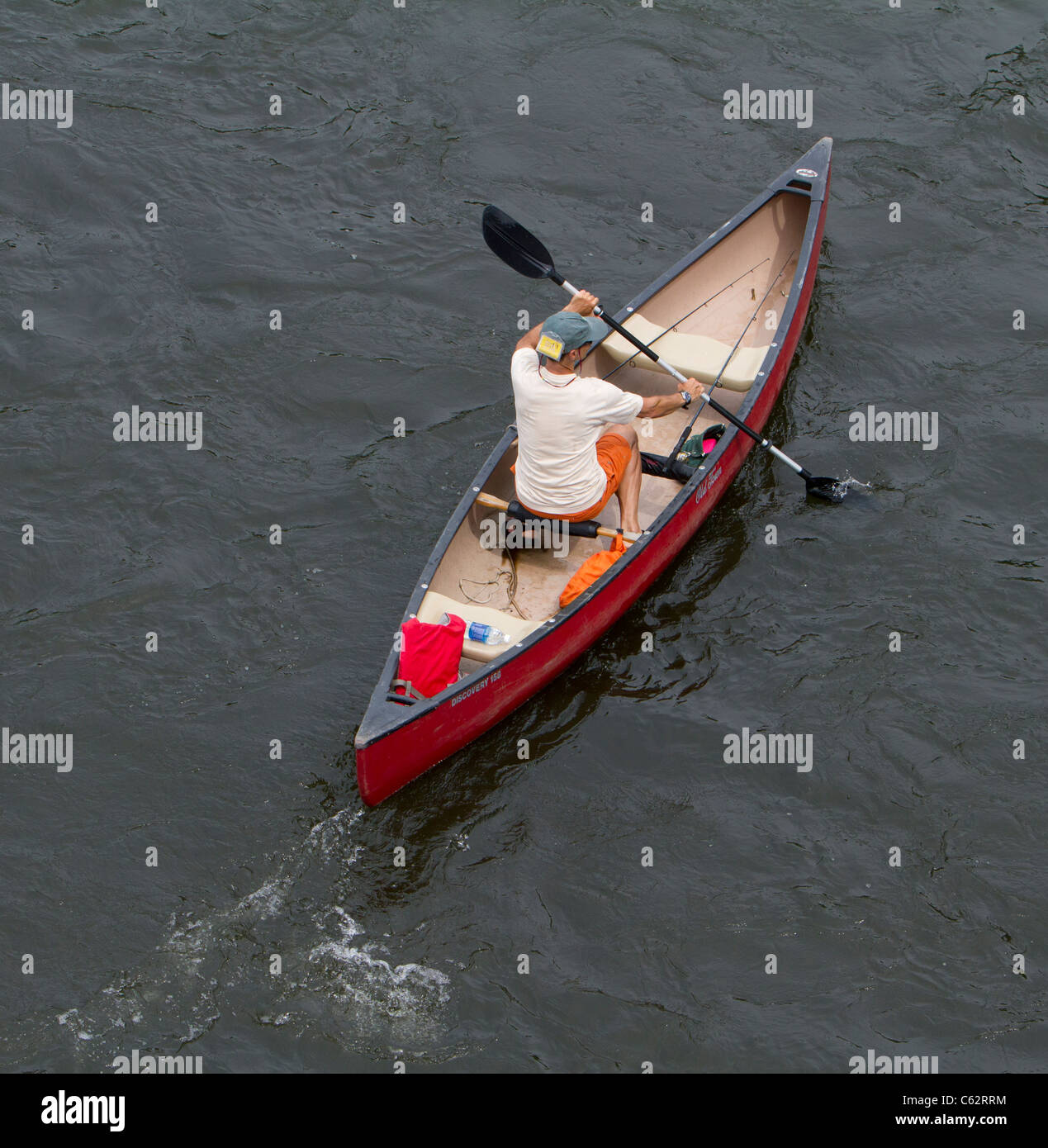Fisherman in a canoe with two fishing poles Stock Photo Alamy