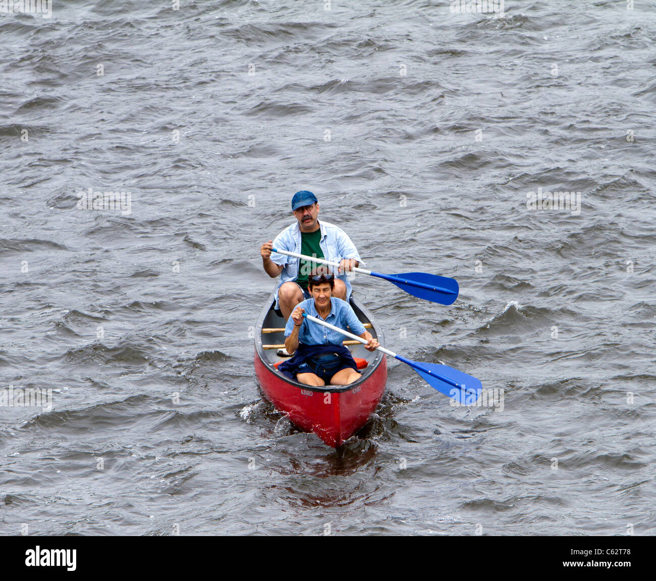 Two seniors man and woman couple paddling a canoe Stock Photo - Alamy